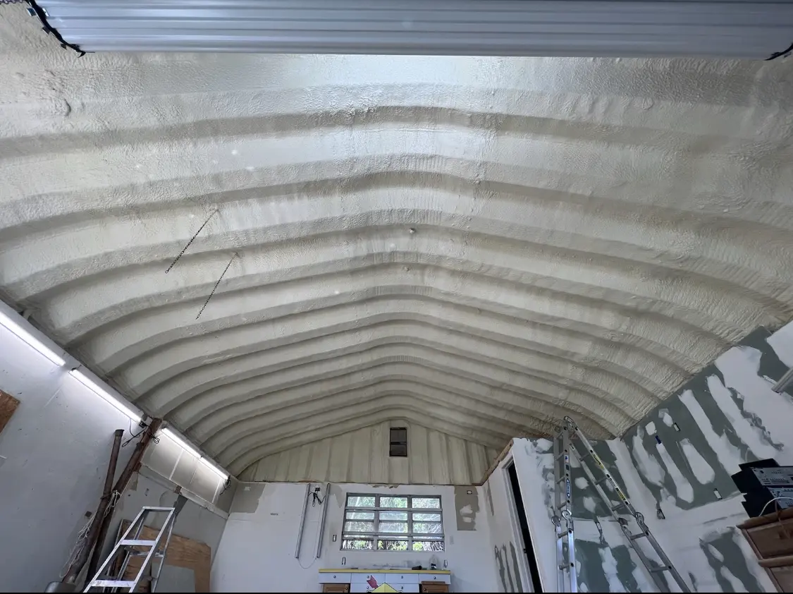 Spray polyurethane foam applied to the underside of a metal roof deck in Caln